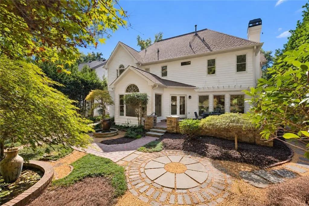 Multi-level backyard landscaping with brick and stone pathways