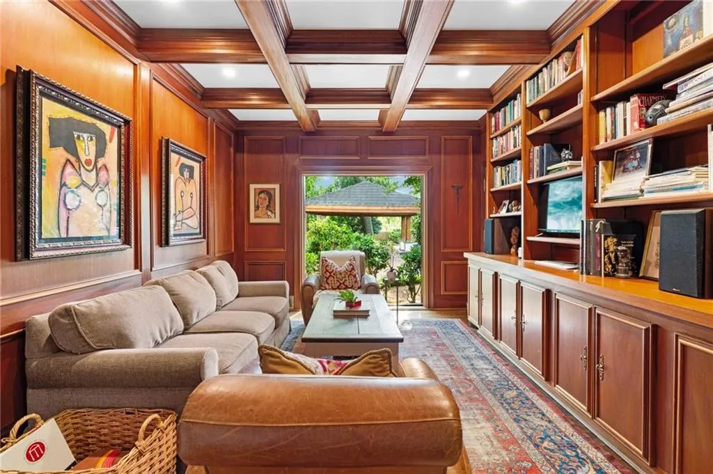Coffered ceiling and paneled library over looking the pool