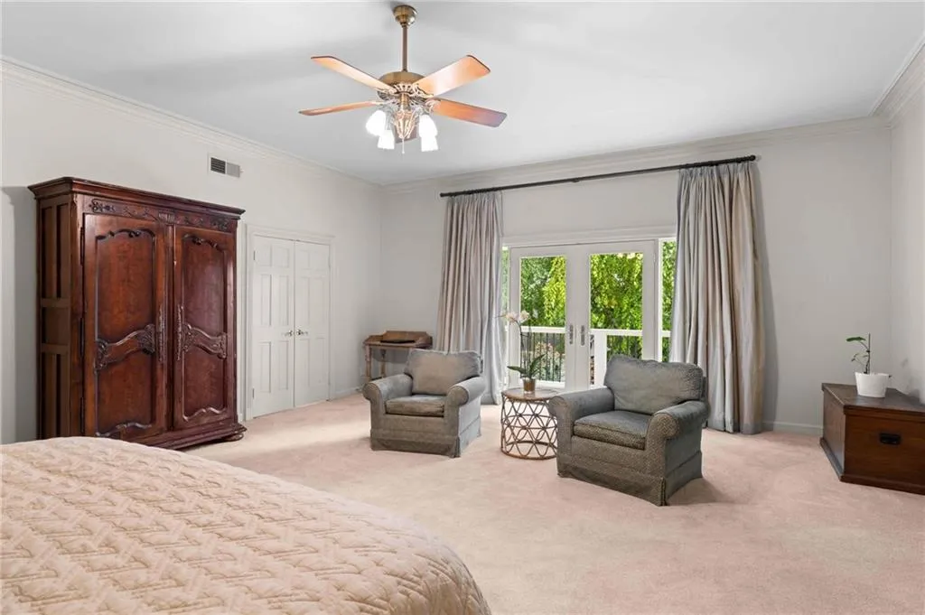 Primary bedroom with sitting area overlooking the pool