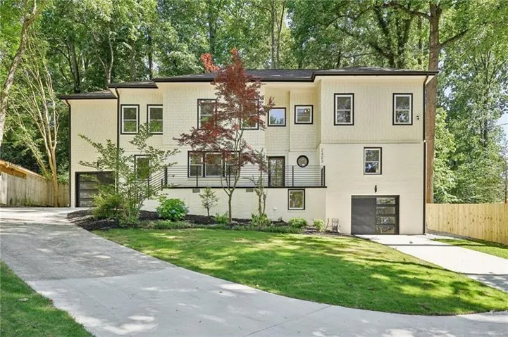 View of front of property featuring a garage and concrete driveway