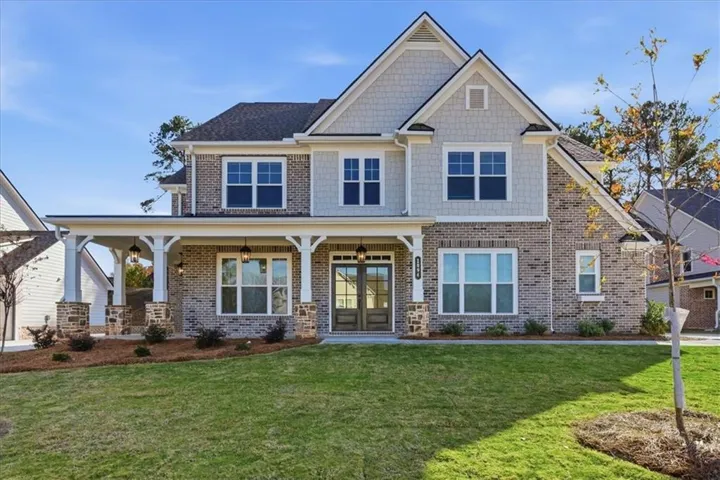 Traditional-style residence featuring a brick and shake siding exterior
