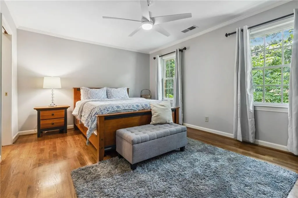3rd upstairs ensuite bedroom with ceiling fan and closet.