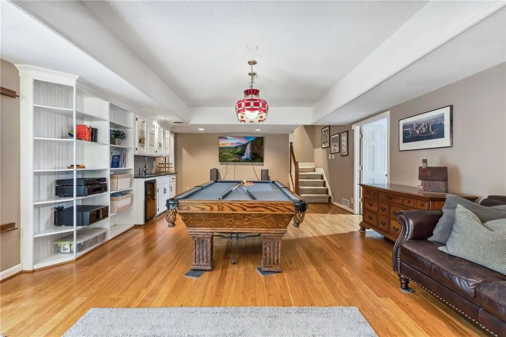 Recreation room featuring light wood-type flooring, billiards, and wine cooler