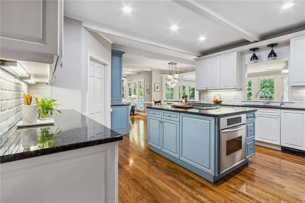 Kitchen with brick backsplash and granite counters.