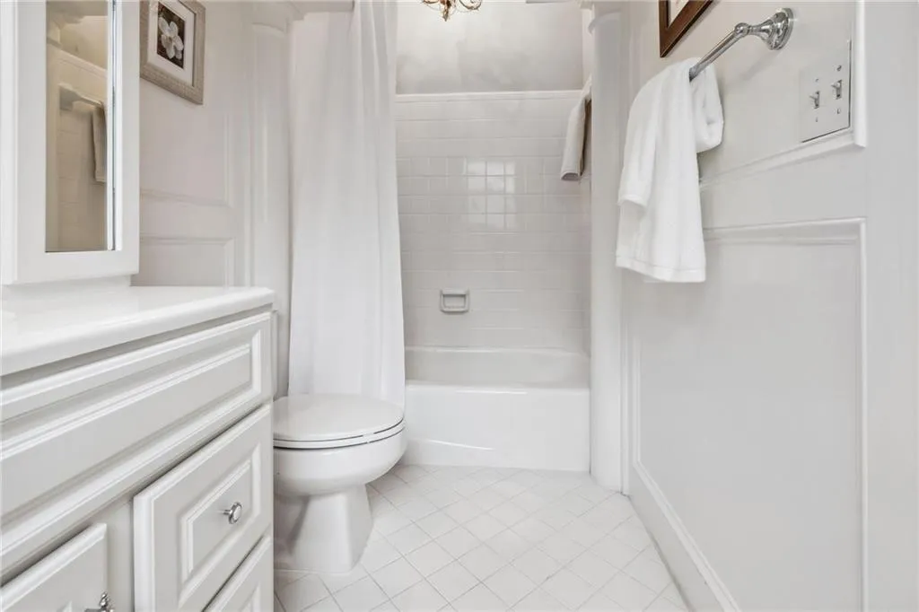 Full bathroom off main floor bedroom featuring vanity with extensive cabinet space.
