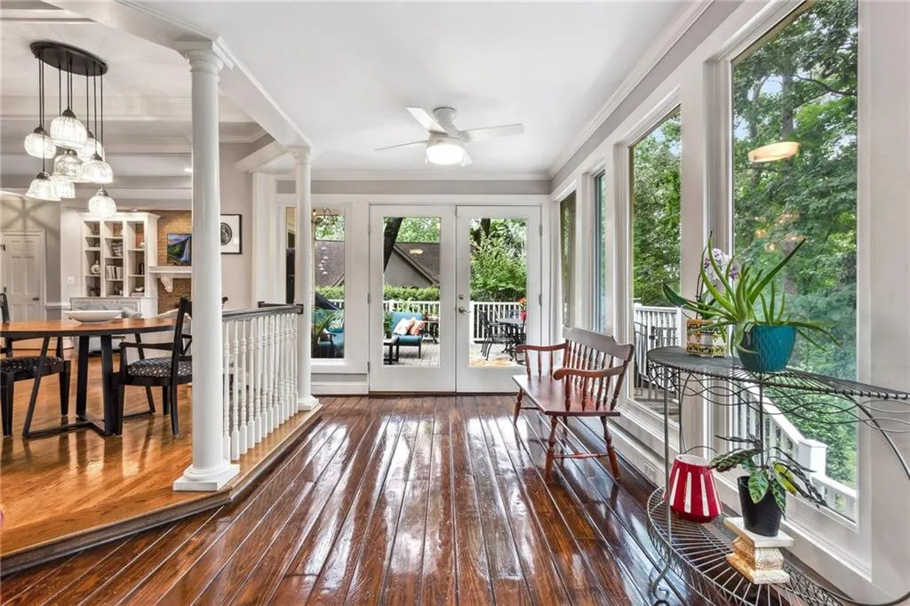 Sunroom with abundant natural light, ceiling fans, french doors leading to patio