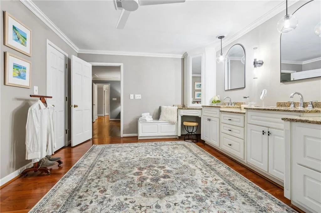 Primary Bathroom featuring two walk in closets