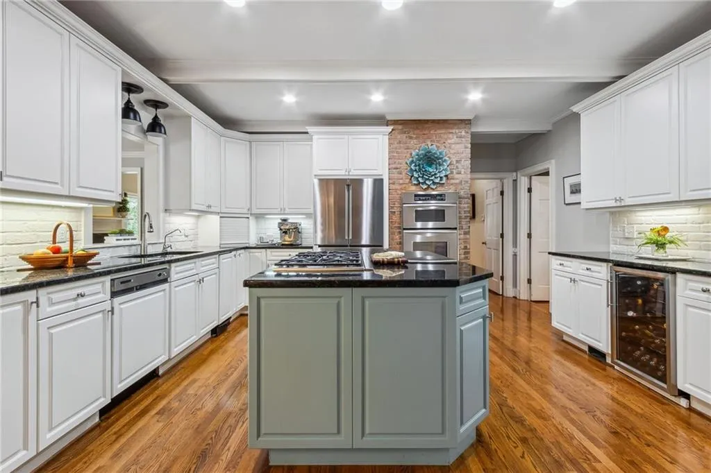 Kitchen with stainless steel appliances, beverage cooler, and a kitchen island with gas 5-burner cooktop