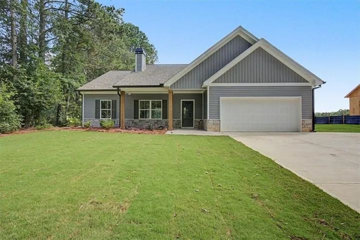 Craftsman-style home featuring a covered front porch with wood columns and stone accents
