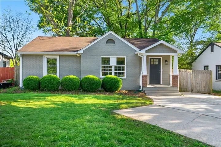 View of front of house with covered porch and brick siding