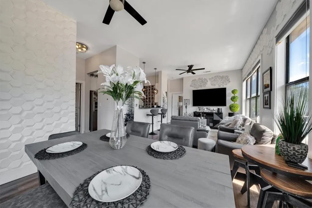 Dining space featuring ceiling fan and dark hardwood / wood-style floors