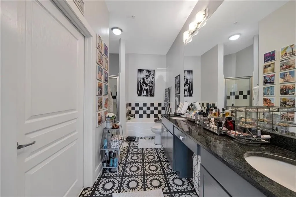 Spacious master bath  featuring hand painted floor tiles.