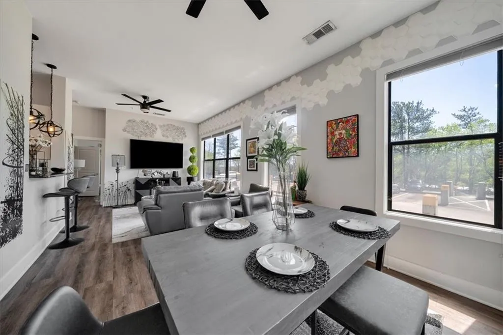 Dining room with dark hardwood / wood-style flooring and ceiling fan