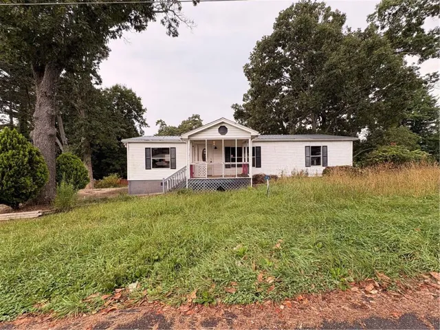 White exterior with dark window shutters