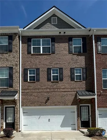 Brick exterior with a peaked roofline and shake siding accent