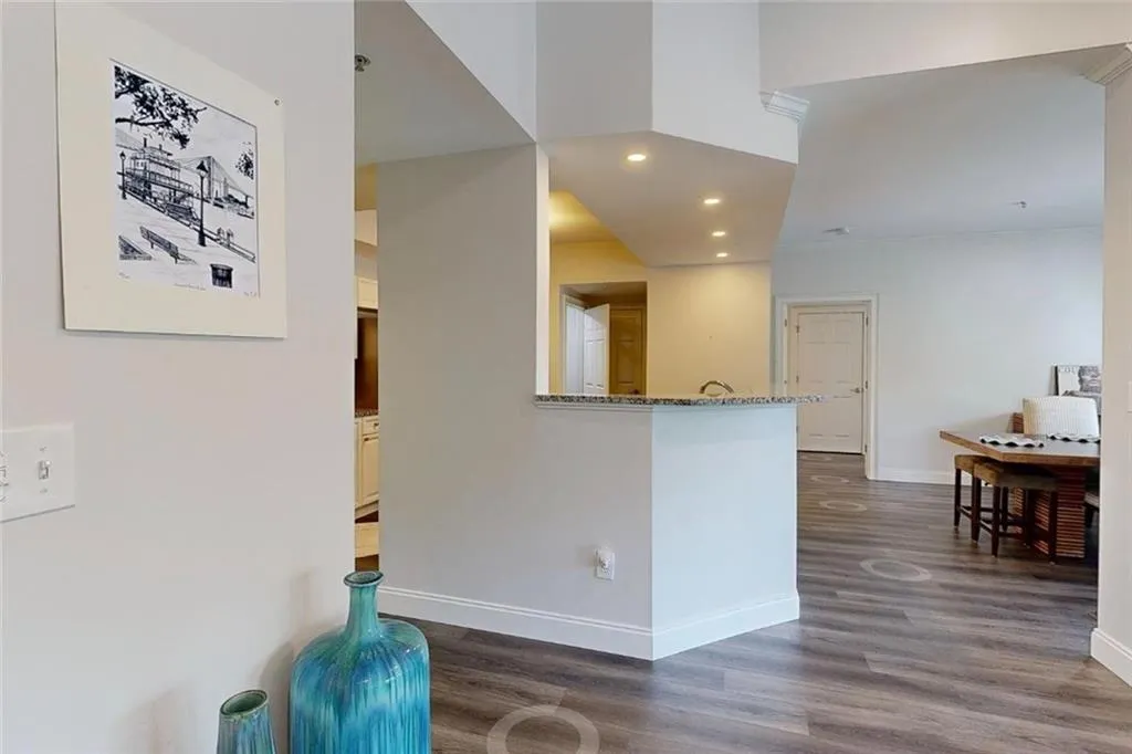 Kitchen featuring dark wood finished floors, recessed lighting, and stone countertops