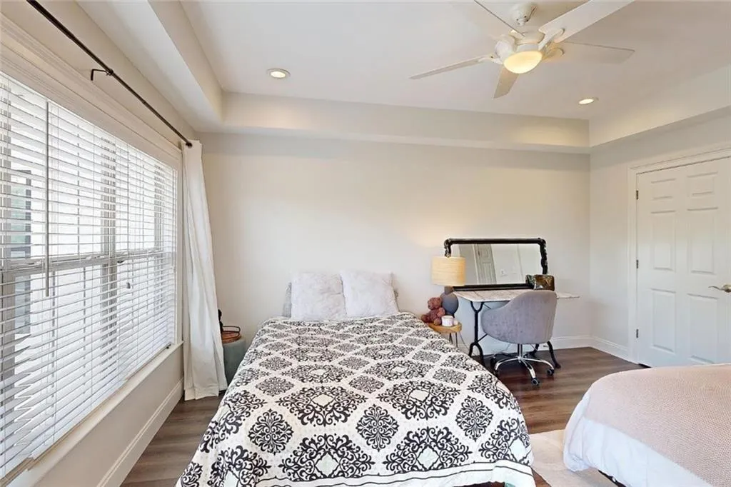 Bedroom with wood finished floors, a ceiling fan, and recessed lighting