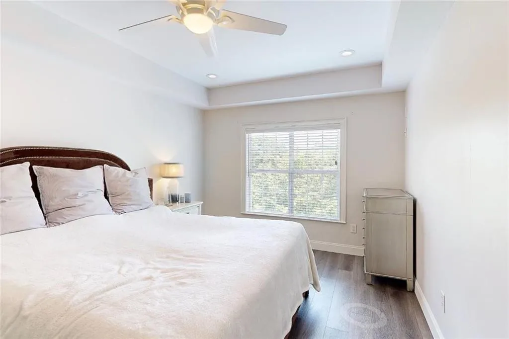 Bedroom featuring dark wood-style floors, a ceiling fan, and recessed lighting