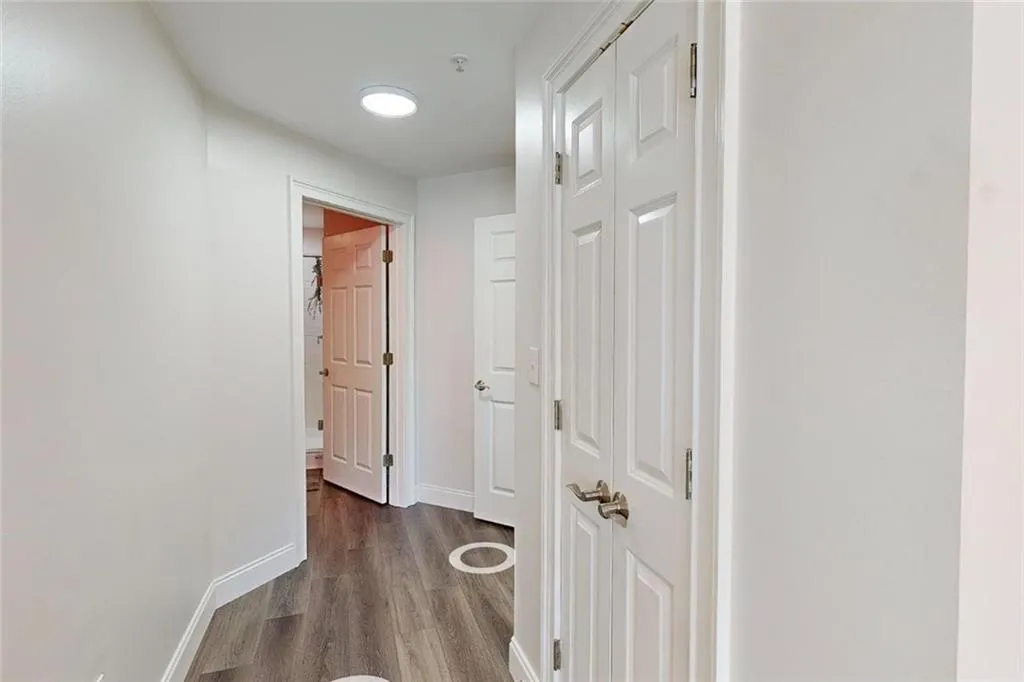 Corridor with wood finished floors and baseboards