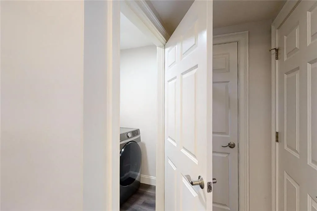Laundry area featuring washer / clothes dryer and dark wood-style floors