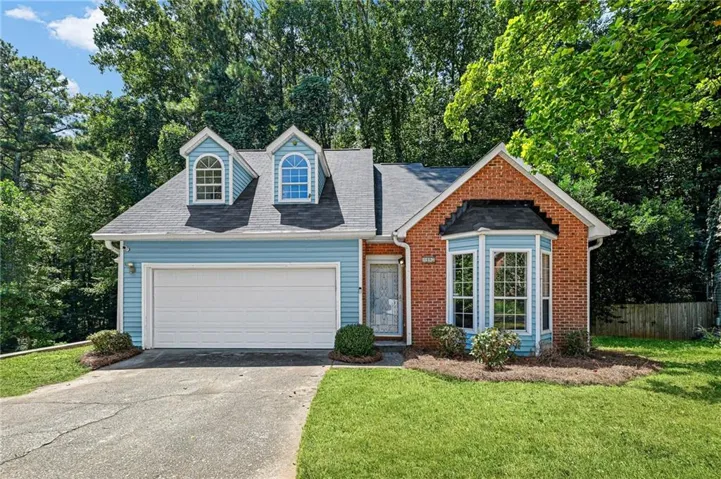Brick and siding exterior with a two-car garage