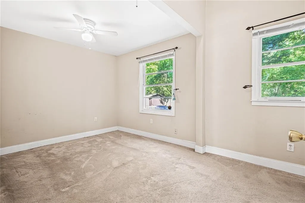 Spare room with carpet flooring and a ceiling fan