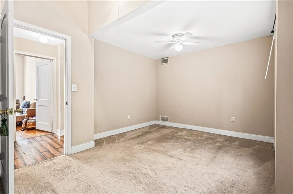 Empty room featuring carpet and a ceiling fan