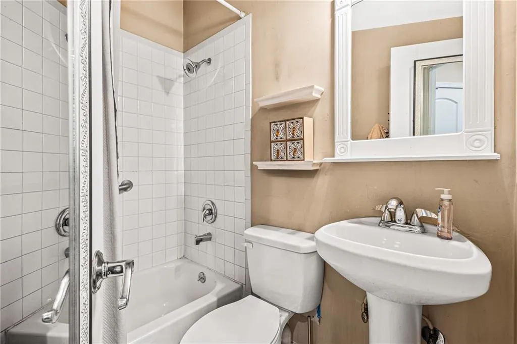 Bathroom with shower / washtub combination and toilet
