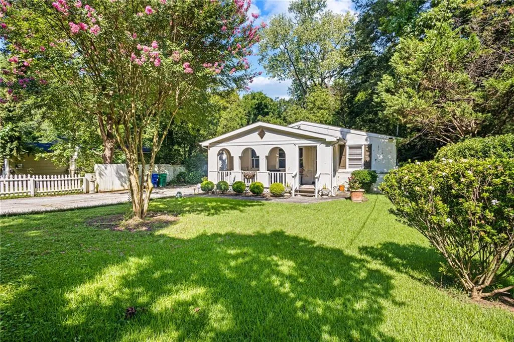 View of front of house with a porch and stucco siding