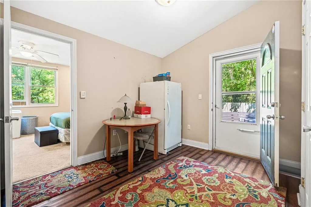 Entryway with lofted ceiling, wood finished floors, and a ceiling fan