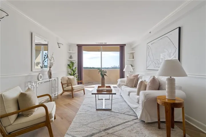 Living room with light wood-style floors, ornamental molding, and floor to ceiling windows