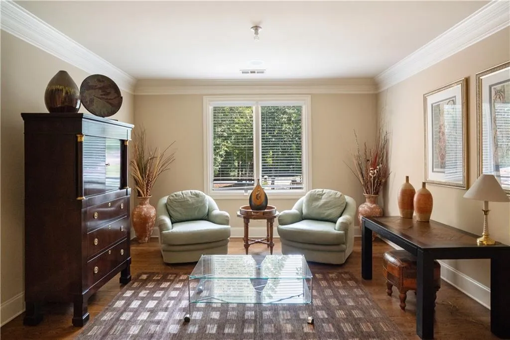 Sitting room featuring dark hardwood / wood-style floors and ornamental molding Sitting room featuring dark hardwood / wood-style floors and ornamental molding