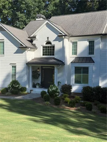 White brick and siding exterior with a dark roof
