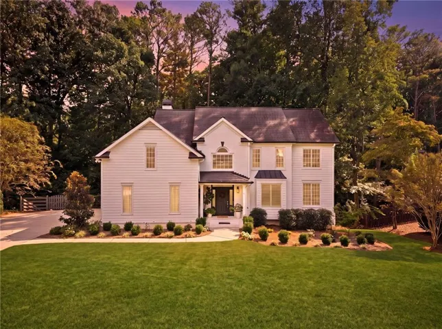 White clapboard siding exterior with a dark-pitched roof