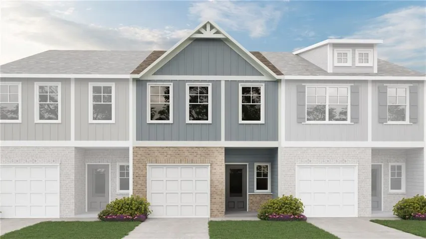 Townhome exterior with a light blue siding and brick veneer facade