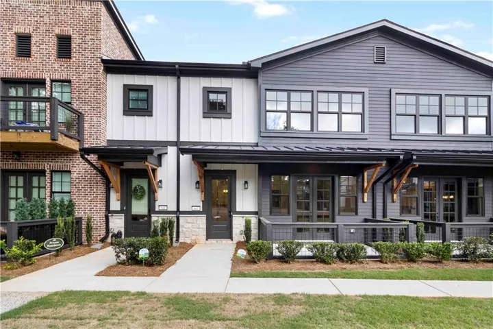 Contemporary facade with mixed material construction, featuring brick and siding