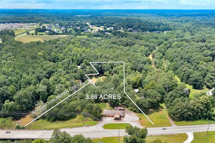 3.86 acres with substantial tree coverage