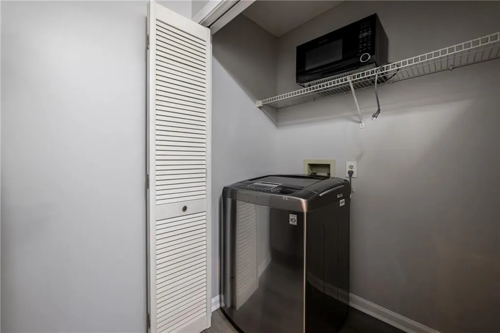 Laundry area featuring washer / clothes dryer and wood finished floors