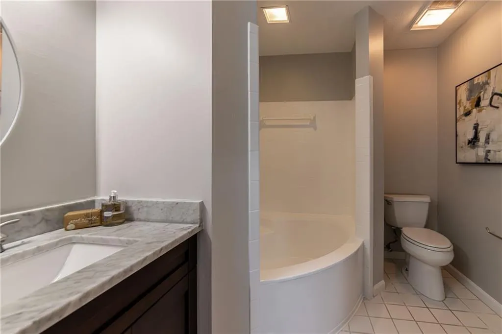 Full bath featuring light tile patterned floors, vanity, and bathtub / shower combination