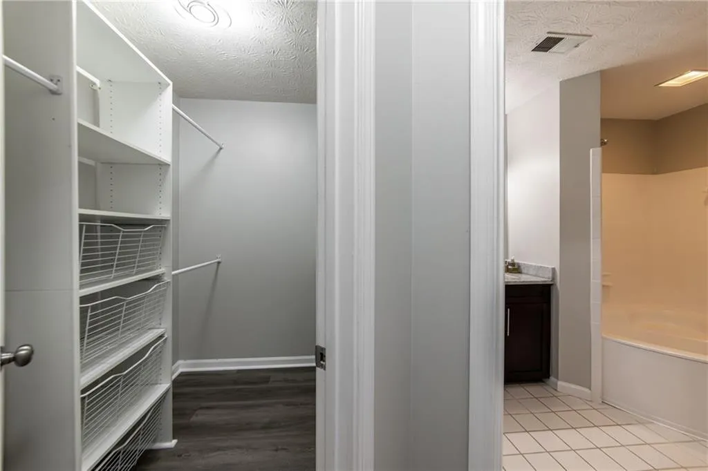 Spacious closet with light tile patterned flooring