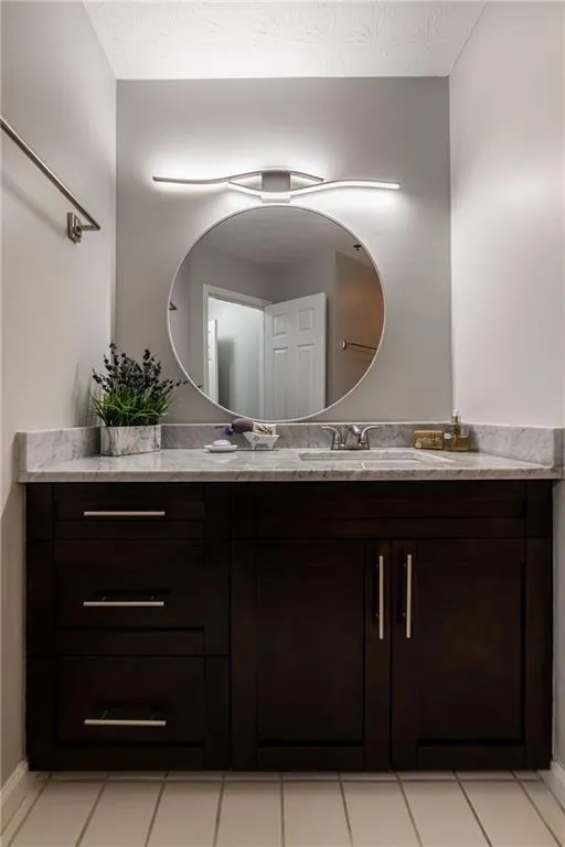 Bathroom with vanity and light tile patterned floors