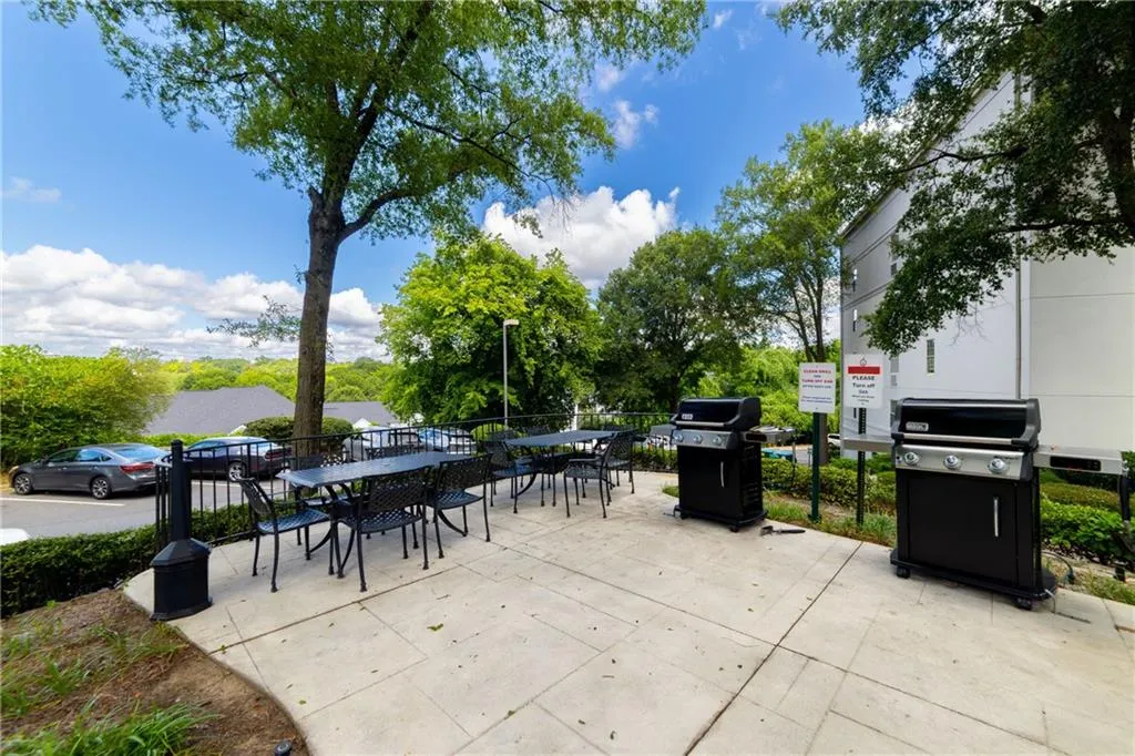 View of patio featuring outdoor dining space and area for grilling
