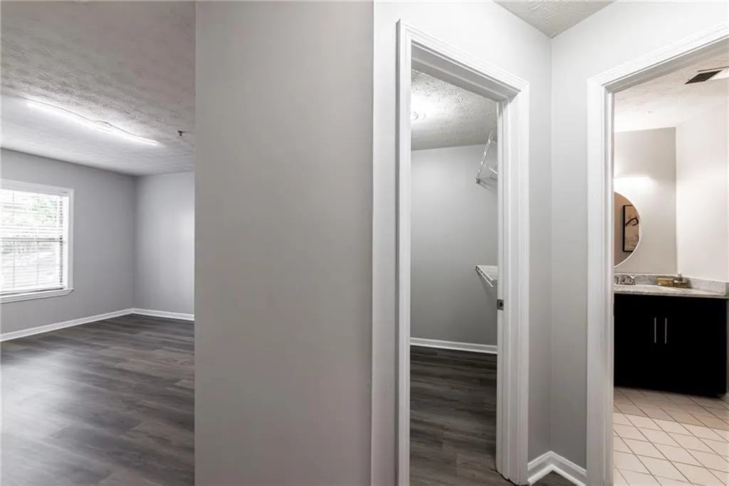 Corridor with a textured ceiling and dark wood finished floors