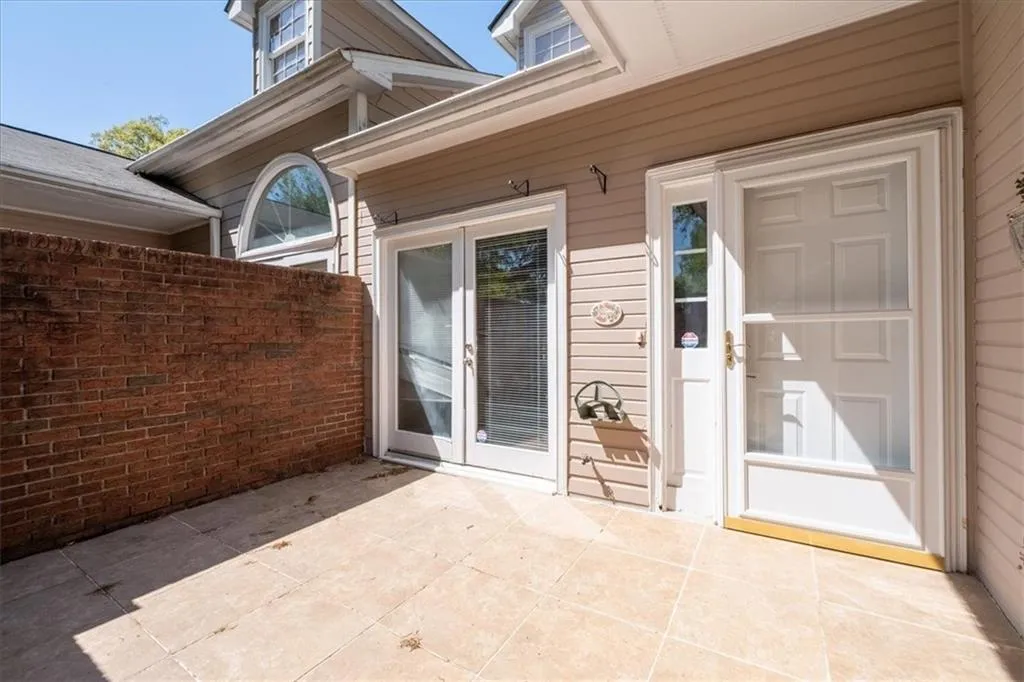 View of exterior entry featuring a patio