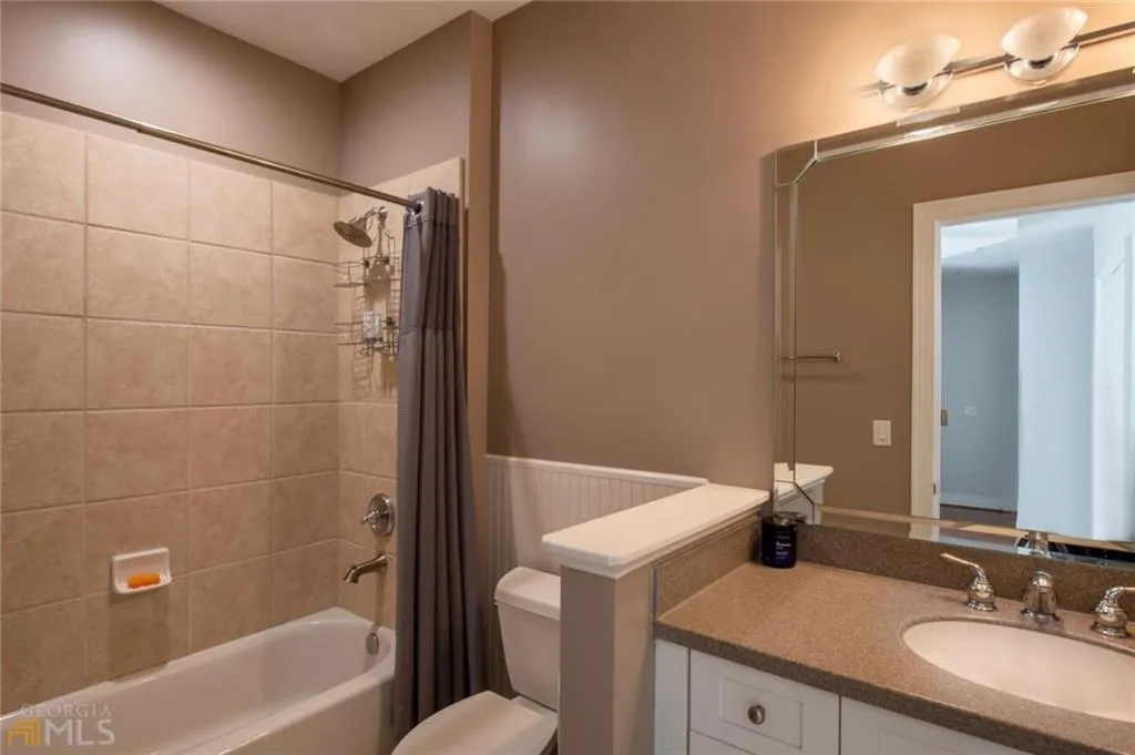 Full bath featuring shower / bathtub combination with curtain and vanity