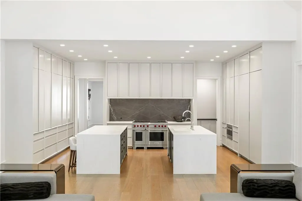 This chef's kitchen seamlessly integrates hidden features and functionality including the premium Wolf and Sub Zero appliancess behind sleek custom cabinets for a sophisticated and clean lined appeal.