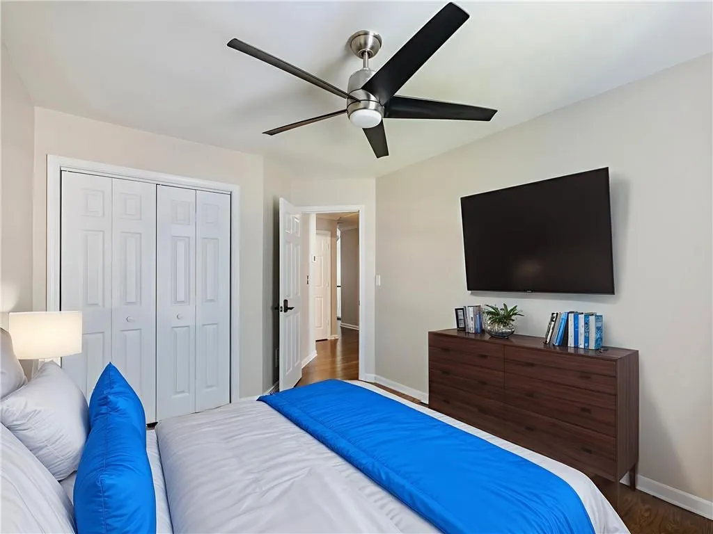 Bedroom featuring a closet, wood finished floors, and ceiling fan