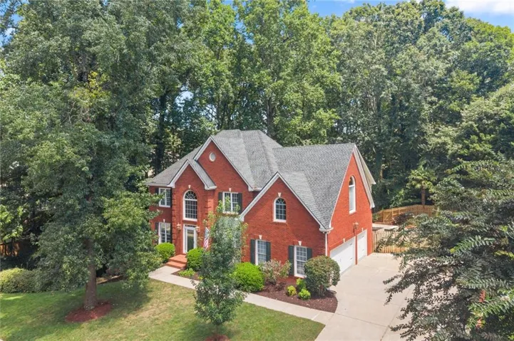Red brick exterior with multiple gables and dormers