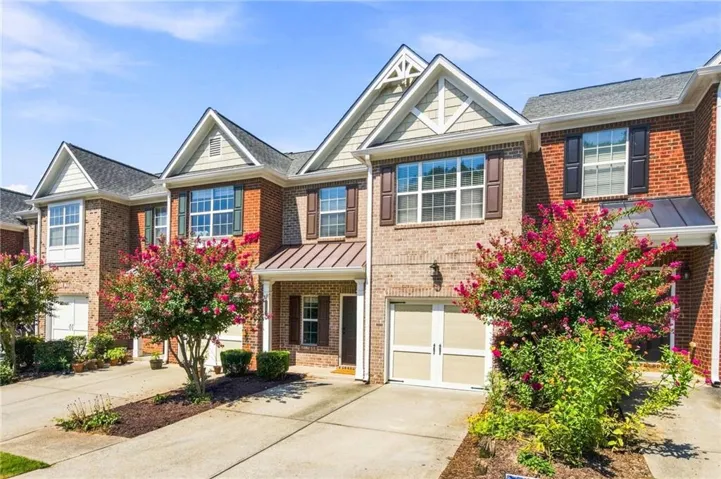 Brick exterior with gabled rooflines, decorative dormers, and shuttered windows