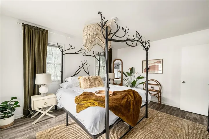 Bedroom featuring wood finished floors and baseboards